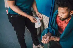 Image: Man holds his hand after his automatic door injury. An automatic door injury lawyer can help you get compensation for your injury.